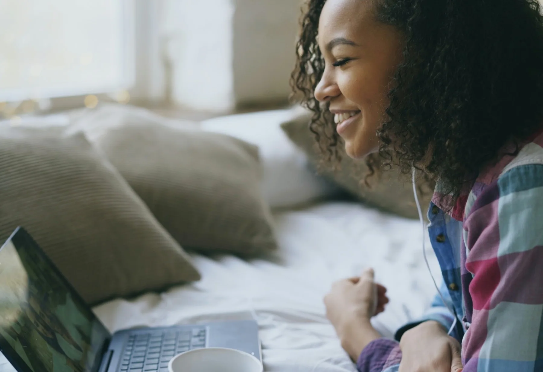 Young woman smiling during a video call from home